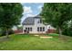 Lush backyard featuring a spacious deck, mature trees, and a well-kept lawn at 337 Botan Way, Hillsborough, NC 27278