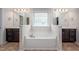 Bathroom with double vanity sinks and a large soaking tub between them at 337 Botan Way, Hillsborough, NC 27278