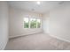 Sunny bedroom with a window and neutral carpet at 337 Botan Way, Hillsborough, NC 27278