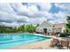 Inviting community pool area with a clubhouse, seating, and a relaxing atmosphere at 337 Botan Way, Hillsborough, NC 27278