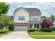 Charming two-story home with a stone-accented garage and beautiful landscaping at 337 Botan Way, Hillsborough, NC 27278