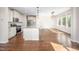 Open-concept kitchen with modern appliances and hardwood floors, ideal for entertaining at 337 Botan Way, Hillsborough, NC 27278