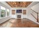 Inviting living room featuring a fireplace, built-ins, and a unique wood-paneled ceiling at 337 Botan Way, Hillsborough, NC 27278