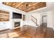 Spacious living room with a fireplace, built-in shelving, and hardwood floors at 337 Botan Way, Hillsborough, NC 27278