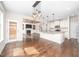Bright, open-concept space with hardwood floors, a kitchen island, and cozy fireplace at 337 Botan Way, Hillsborough, NC 27278
