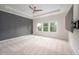 Large main bedroom with a tray ceiling, neutral carpet, and lots of natural light at 337 Botan Way, Hillsborough, NC 27278