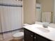 Bathroom with a toilet, white sink, and a shower with a blue and white shower curtain at 3650 Pleasants Ridge Dr, Wake Forest, NC 27587