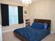 Bedroom featuring a bed with blue covers, dark curtains, and a decorative chandelier at 3650 Pleasants Ridge Dr, Wake Forest, NC 27587