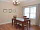 Cozy dining area with a chandelier, four chairs, a white table, and bright window light at 3650 Pleasants Ridge Dr, Wake Forest, NC 27587