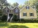 Beautiful two-story home with brick and siding exterior, a well-manicured lawn, and mature trees at 3650 Pleasants Ridge Dr, Wake Forest, NC 27587