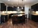 Well-appointed kitchen with dark cabinetry, granite counters, an island with seating, and modern appliances at 3650 Pleasants Ridge Dr, Wake Forest, NC 27587