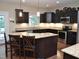 Modern kitchen with dark cabinets, granite countertops, stainless steel appliances, and a large island at 3650 Pleasants Ridge Dr, Wake Forest, NC 27587