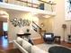 Open-concept living room featuring hardwood floors, modern decor, and lots of natural light at 3650 Pleasants Ridge Dr, Wake Forest, NC 27587