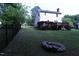 Fenced backyard with a stone fire pit offers privacy and a cozy outdoor gathering space at 3832 Doeskin Dr, Apex, NC 27539