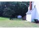 White two-story home featuring a fenced backyard with a shed, grassy lawn and mature trees at 3832 Doeskin Dr, Apex, NC 27539