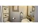 Neutral toned bathroom featuring toilet, white vanity with a black faucet, and built-in shelves at 3832 Doeskin Dr, Apex, NC 27539