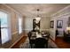 A dining room featuring a chandelier, table with seating for six, and natural light at 3832 Doeskin Dr, Apex, NC 27539