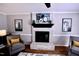 Close up on the fireplace with decorative artwork and seating at 3832 Doeskin Dr, Apex, NC 27539