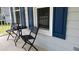 Relaxing front porch with table, chairs, blue shutters, and cozy atmosphere at 3832 Doeskin Dr, Apex, NC 27539
