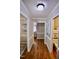 Hallway with hard wood floors, neutral paint, and access to rooms and storage at 3832 Doeskin Dr, Apex, NC 27539
