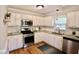 Well-lit kitchen with stainless steel appliances, white cabinetry, and subway tile backsplash at 3832 Doeskin Dr, Apex, NC 27539