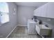 Functional laundry room with a white sink, washer, dryer and overhead cabinets at 3832 Doeskin Dr, Apex, NC 27539