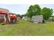 Spacious backyard featuring a storage shed, patio, and deck area for outdoor living at 402 S Wilma St, Angier, NC 27501