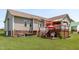 Well-maintained home exterior with a spacious deck featuring an outdoor kitchen and cozy pergola at 402 S Wilma St, Angier, NC 27501