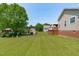Expansive backyard offers a serene setting with storage shed, patio, and deck at 402 S Wilma St, Angier, NC 27501