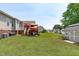 Well-kept backyard with a deck, patio, shed, and plenty of green space for outdoor enjoyment at 402 S Wilma St, Angier, NC 27501