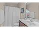 Cozy bathroom with tub and shower combination, white vanity with mirror and decor at 402 S Wilma St, Angier, NC 27501