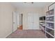 Bedroom with closet and storage shelves, neutral color palette and carpeted flooring at 402 S Wilma St, Angier, NC 27501