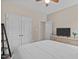 Bedroom featuring a ceiling fan, a double door closet, a TV, and plenty of natural light at 402 S Wilma St, Angier, NC 27501