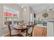 Bright dining area with hardwood floors, a round table with chairs, and natural light from the windows at 402 S Wilma St, Angier, NC 27501