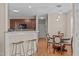 Open dining area with a breakfast bar, pendant lighting, and hardwood floors, perfect for casual dining at 402 S Wilma St, Angier, NC 27501