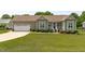 Charming home featuring a two-car garage, landscaped front yard, and a welcoming front porch at 402 S Wilma St, Angier, NC 27501
