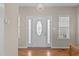 Bright foyer with a decorative chandelier, a front door with glass panes, and hardwood floors at 402 S Wilma St, Angier, NC 27501