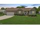 Charming single-story home featuring a well-manicured lawn and an attached two-car garage at 402 S Wilma St, Angier, NC 27501