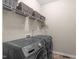 This laundry room features a modern washer and dryer, wire rack and shelf storage at 402 S Wilma St, Angier, NC 27501