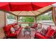 Cozy covered deck boasts comfortable seating, ceiling fan, and scenic backyard views at 402 S Wilma St, Angier, NC 27501