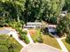 Charming two-story home with lush landscaping, mature trees, and a winding driveway at 4021 Converse Dr, Raleigh, NC 27609