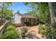 Exterior shot of a home's gray siding, a wooden deck, grill, and lush landscaping at 4021 Converse Dr, Raleigh, NC 27609