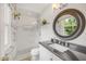 Updated bathroom with a modern glass enclosed shower and a stylish granite vanity at 4021 Converse Dr, Raleigh, NC 27609