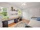This bedroom boasts an office space, hardwood floors, and natural light from two large windows at 4021 Converse Dr, Raleigh, NC 27609