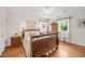 Bright bedroom features hardwood floors, a ceiling fan, and a large wooden bed frame at 4021 Converse Dr, Raleigh, NC 27609