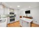 Well-lit kitchen with an island, modern appliances, and ample counter space for food preparation at 4021 Converse Dr, Raleigh, NC 27609