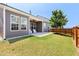 Backyard featuring a covered patio, green lawn, and fenced perimeter at 427 Bluffberry Way, Hillsborough, NC 27278