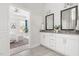 Bathroom featuring double vanity with neutral color palette connecting to bedroom at 427 Bluffberry Way, Hillsborough, NC 27278