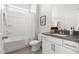 Bright bathroom featuring a shower-tub combo, gray countertop, and white vanity at 427 Bluffberry Way, Hillsborough, NC 27278
