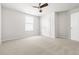 Bright bedroom with neutral carpet, a ceiling fan, and double door closet at 427 Bluffberry Way, Hillsborough, NC 27278